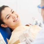 girl smiling in dental chair during exam
