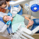 At the dentist young woman patient lying on dental chair