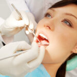 female dental patient having her teeth examined