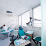 dental room with a dentist and patient in a chair having dental work done