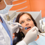 female patient having her teeth examined by a dentist