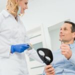 man choosing dental implant with dentist