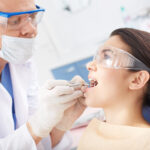 Young girl with open mouth during oral checkup at the dentist